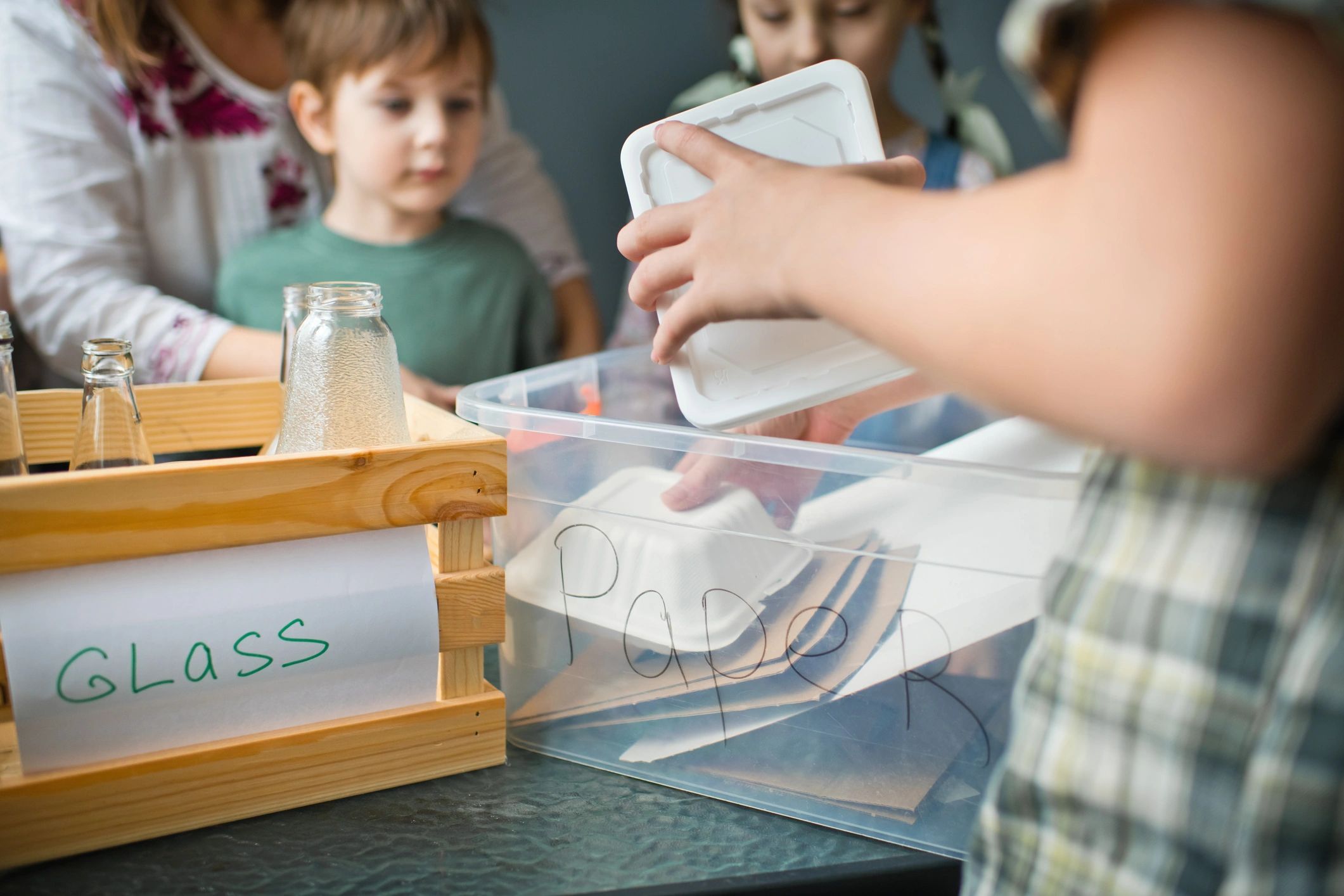 People sorting recyclables into separate containers