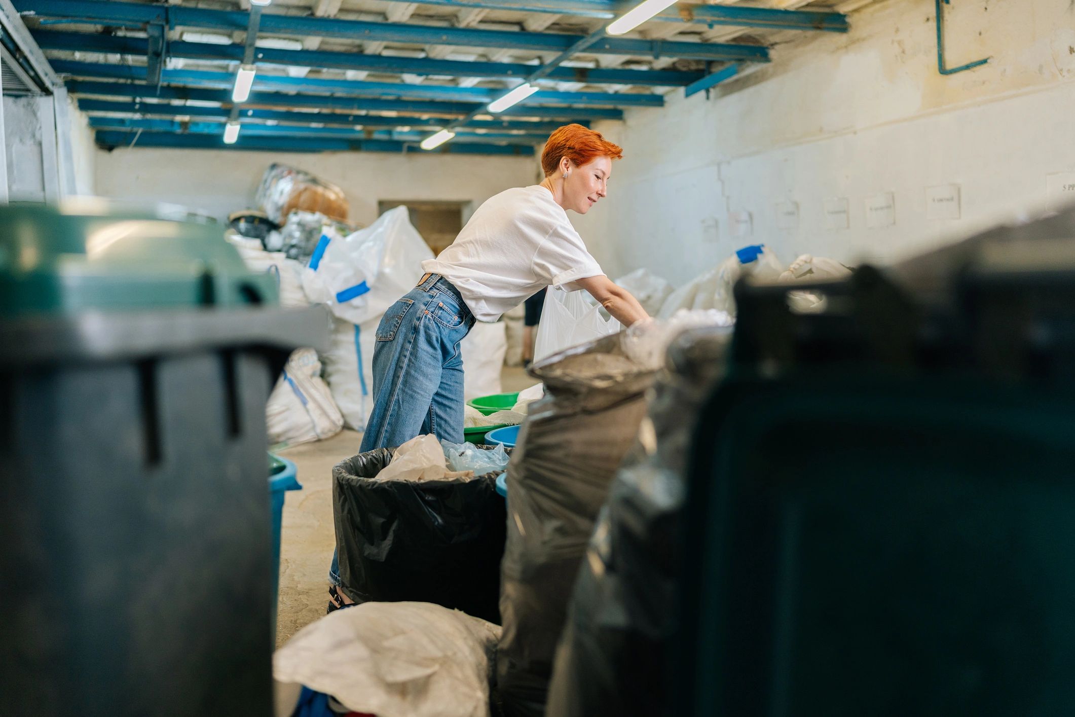 Recycling workers sorting materials at a commercial recycling facility